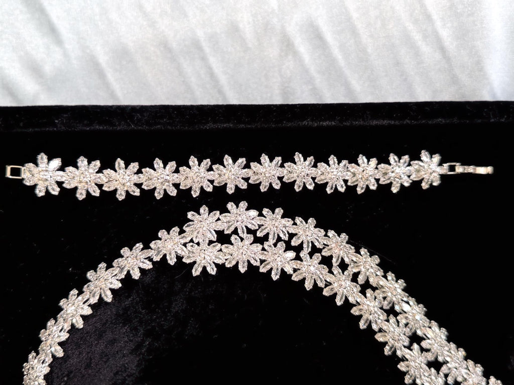 Close-up of silver crystal flower details on the bridal necklace and matching bracelet