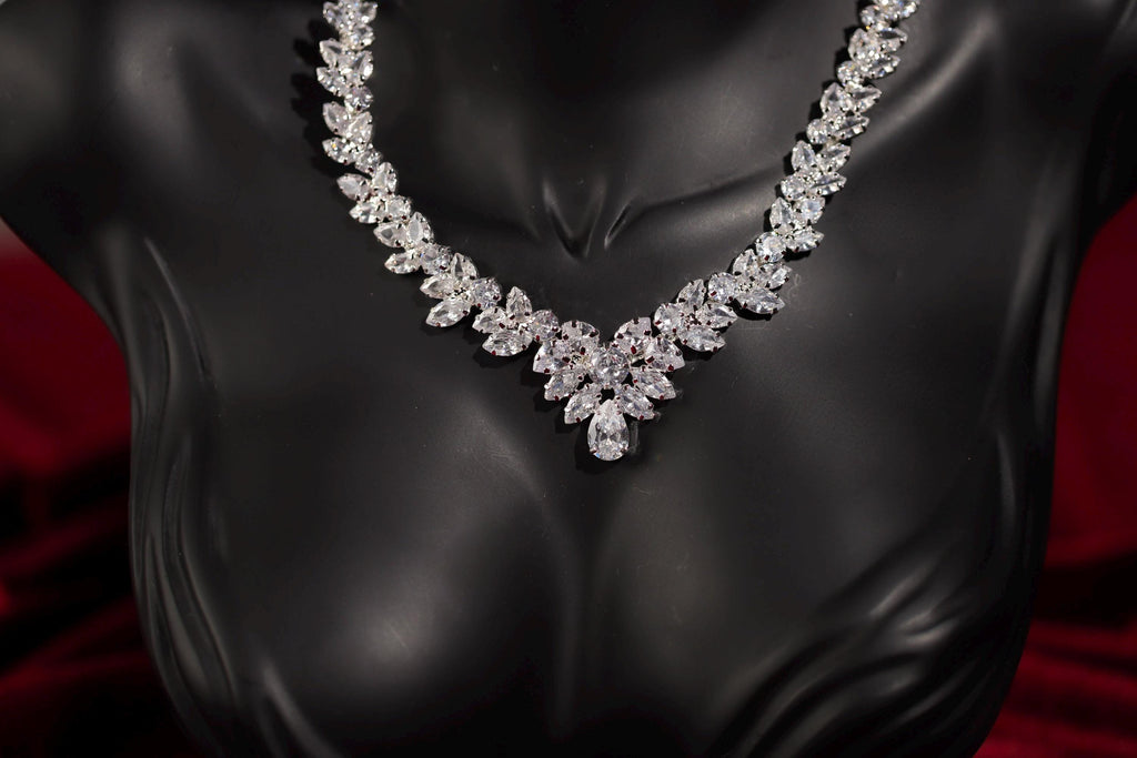 Silver marquise crystal statement necklace shown on a black mannequin bust.
