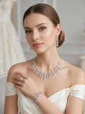 Bride wearing a silver floral crystal and pearl jewelry set with necklace, earrings, bracelet and ring