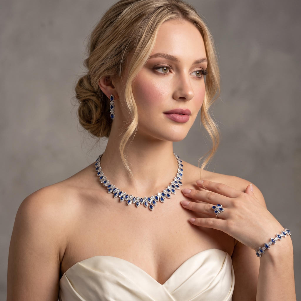 Model in an ivory dress wearing a blue zircon statement necklace with coordinating earrings, bracelet and ring.