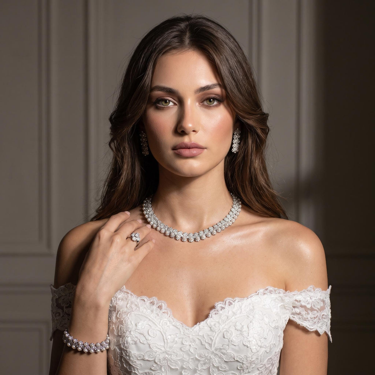 Bride in an off-the-shoulder lace gown wearing a delicate floral necklace and matching faux pearl jewelry.