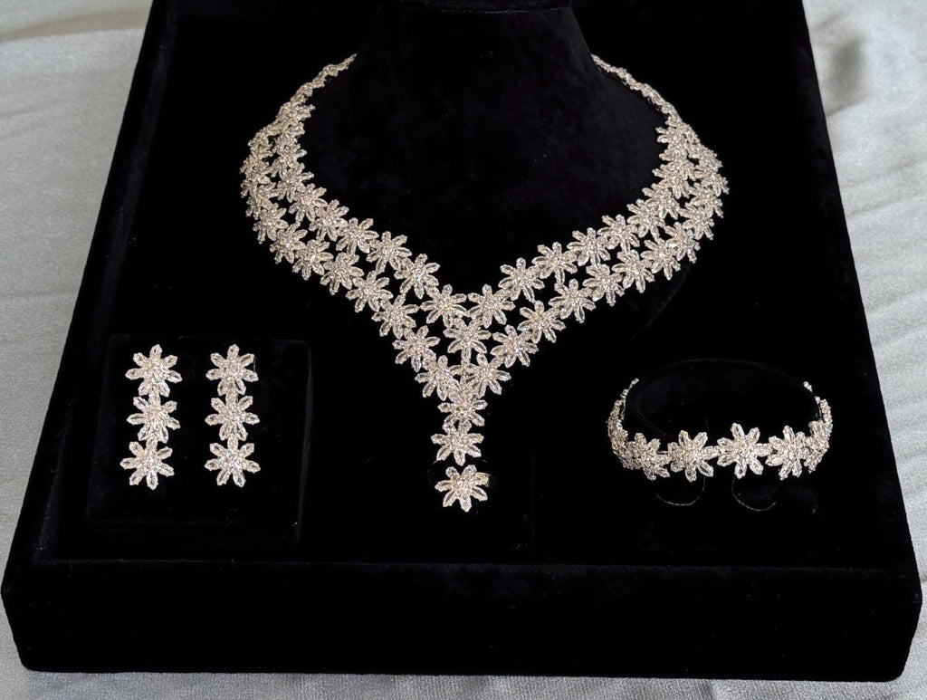 Complete silver floral bridal jewelry set with V-shaped necklace, earrings, bracelet and adjustable ring