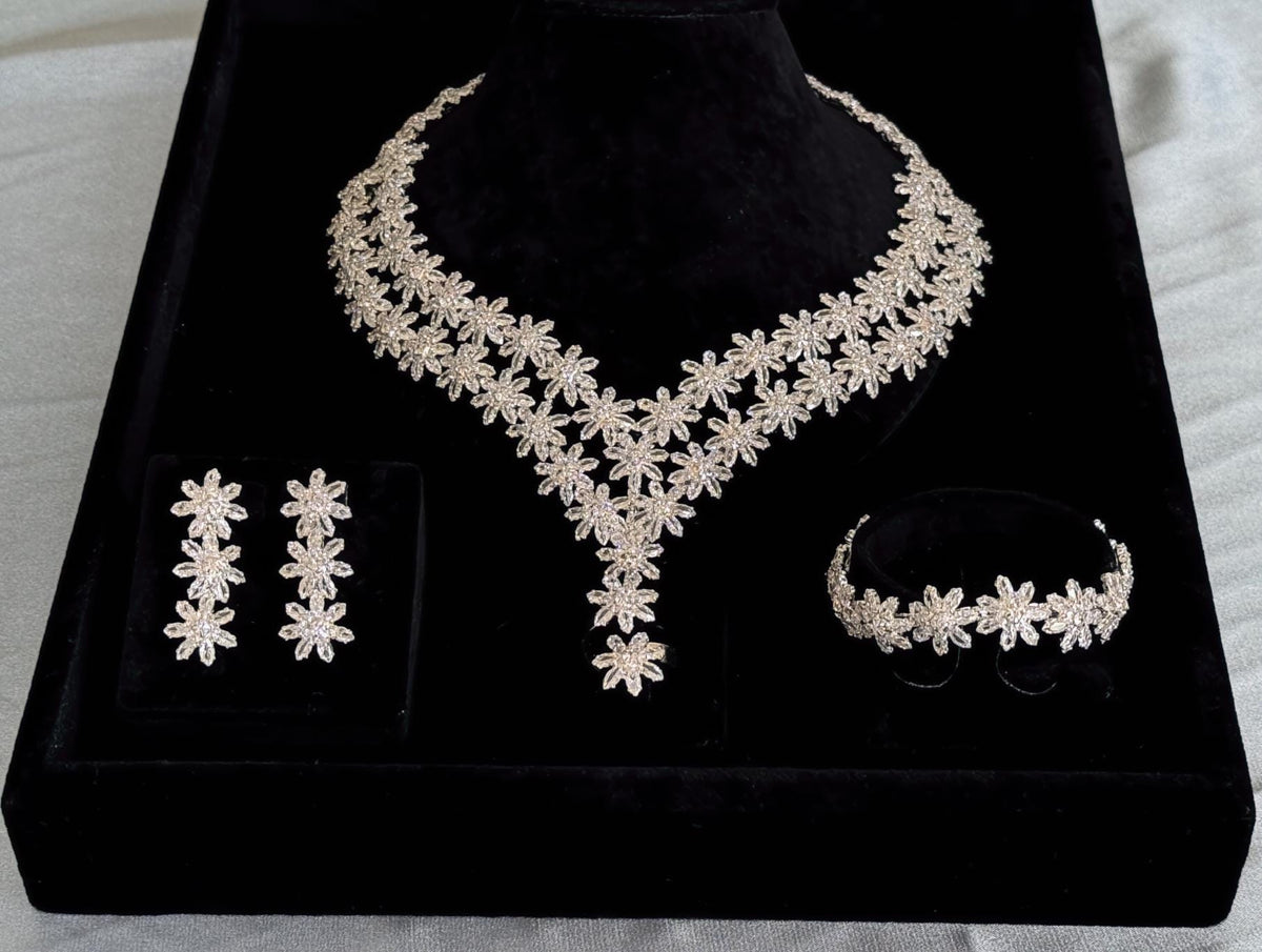 Complete silver floral bridal jewelry set with V-shaped necklace, earrings, bracelet and adjustable ring