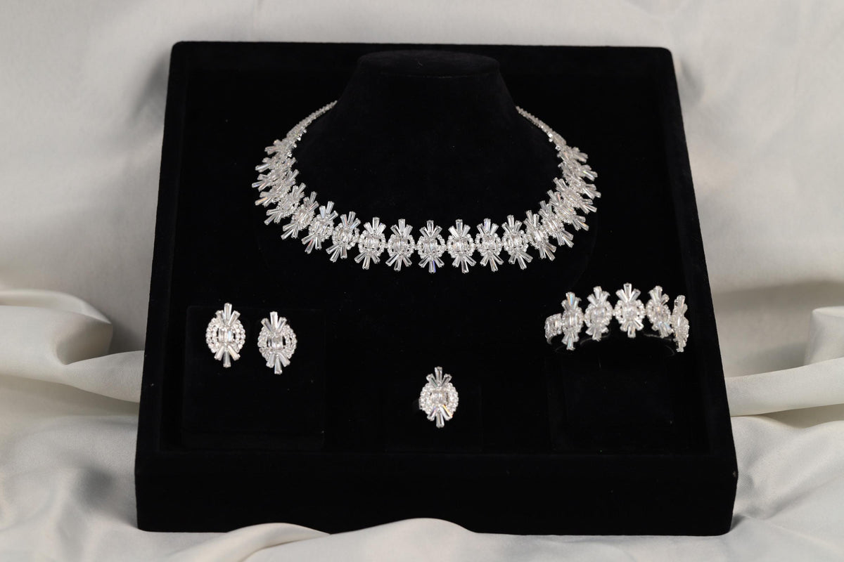 Four-piece silver crystal jewelry set presented in a black gift box