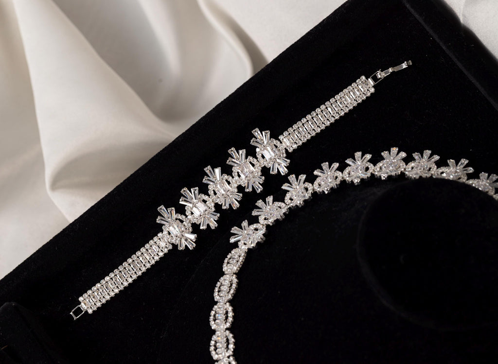Close-up of the matching silver crystal bracelet with floral-inspired geometric details