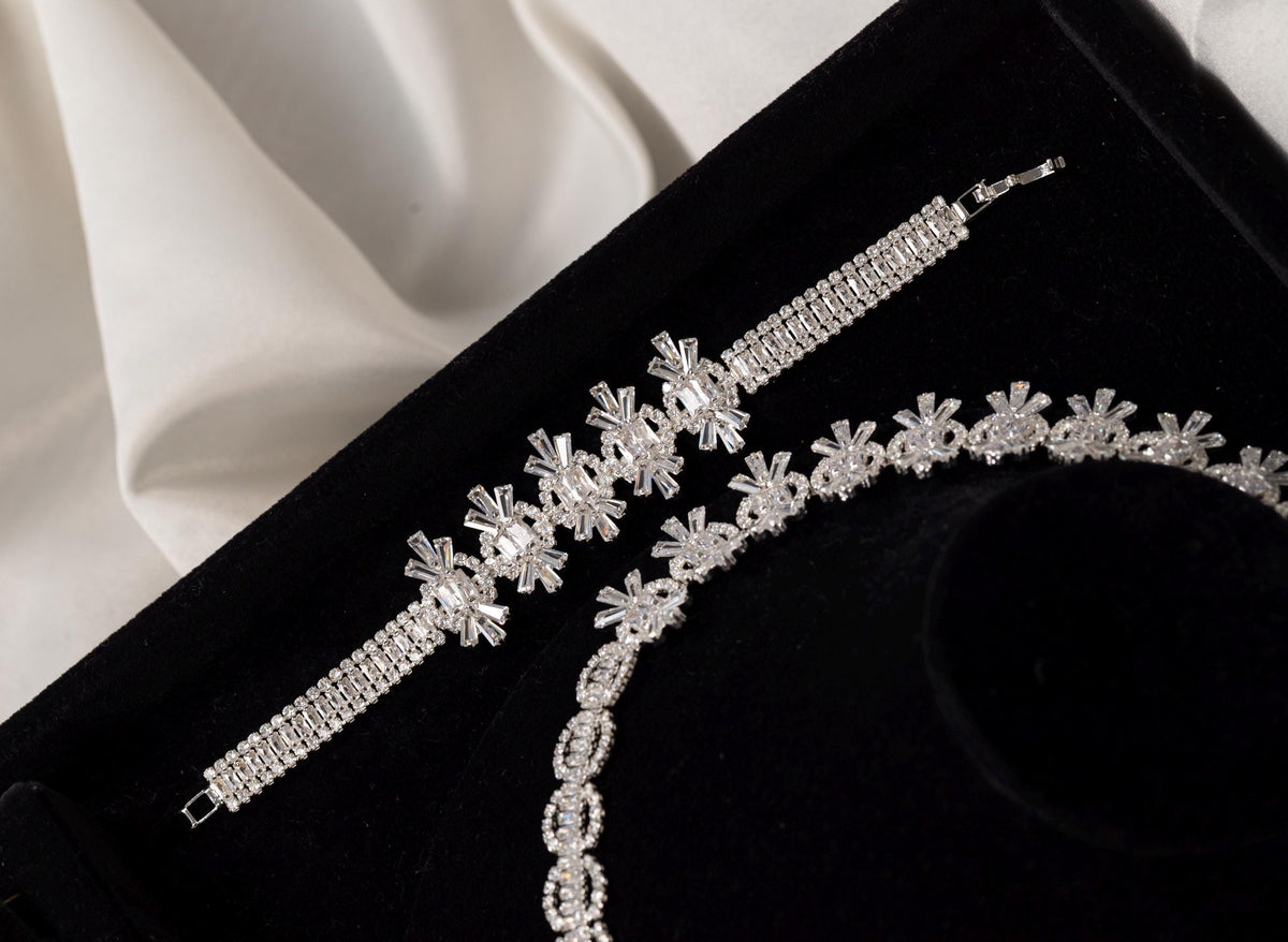 Close-up of the matching silver crystal bracelet with floral-inspired geometric details