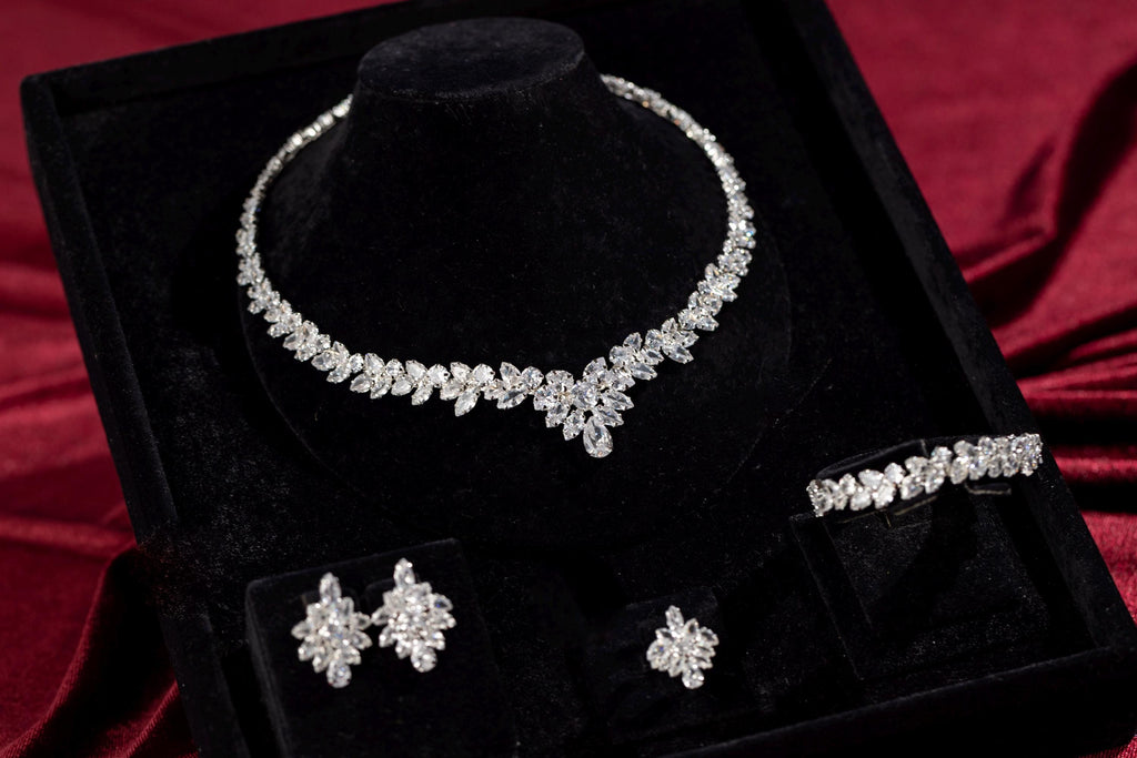 Complete four-piece silver marquise crystal jewelry set arranged in a black presentation box.