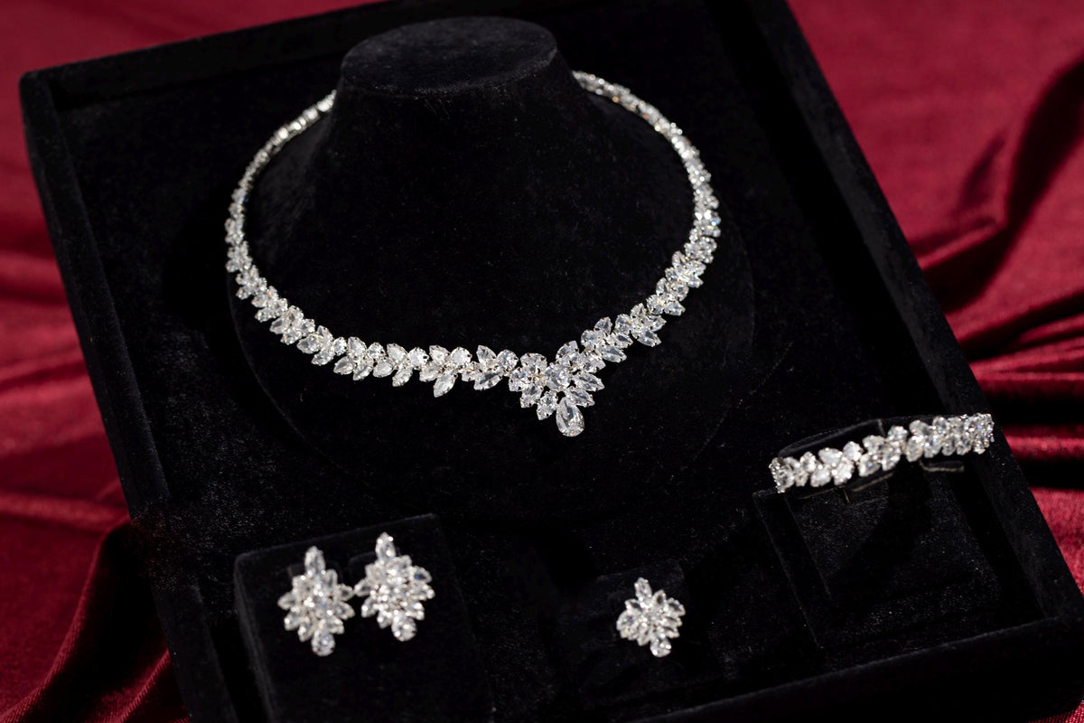 Complete four-piece silver marquise crystal jewelry set arranged in a black presentation box.