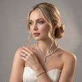 Bride wearing a silver-tone mini flower jewelry set with a Y-shaped necklace, floral drop earrings, bracelet and ring.