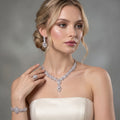 Model wearing a silver-tone teardrop jewelry set with a statement necklace, drop earrings, bracelet and ring