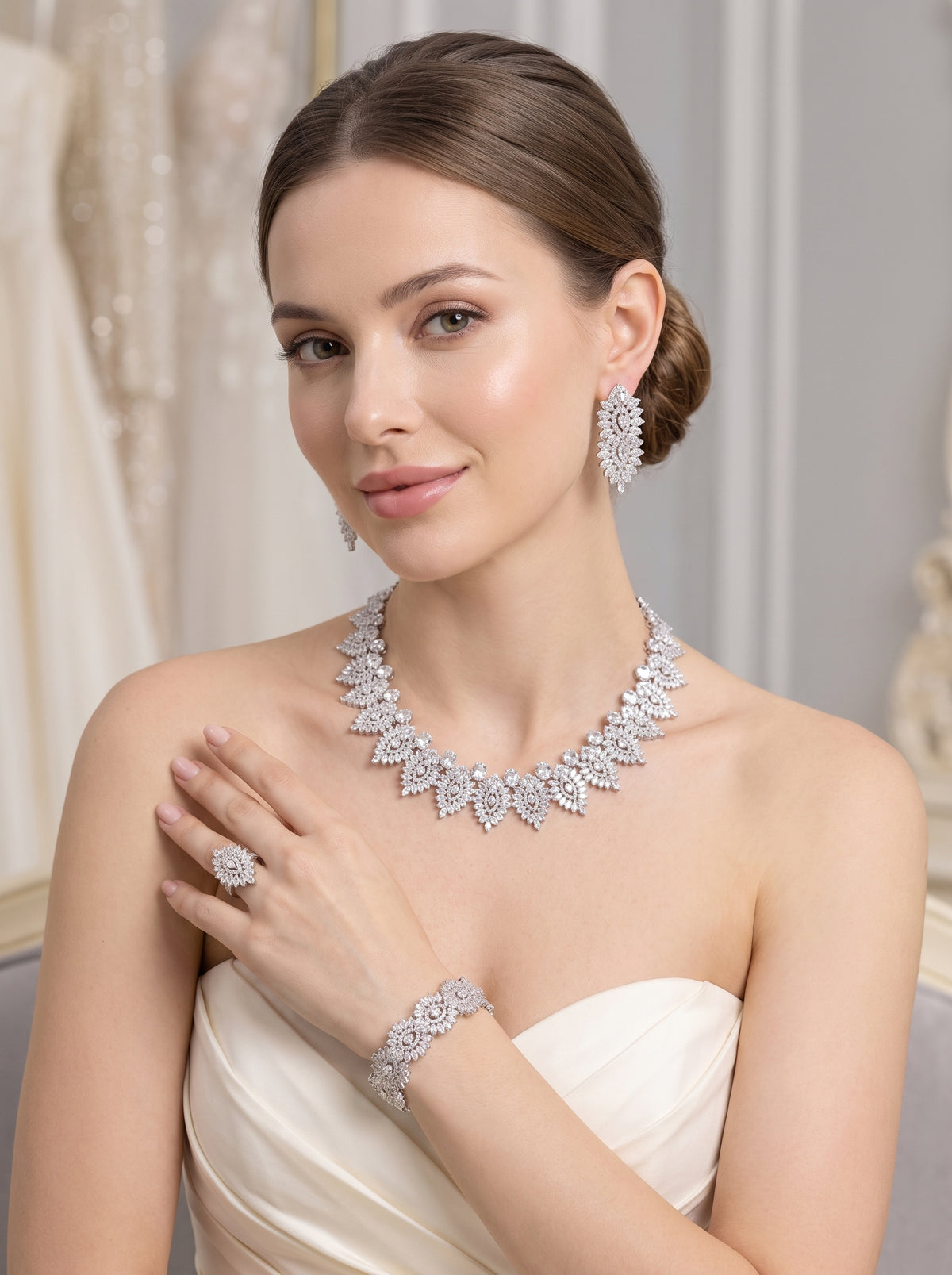 Model wearing a lace-inspired silver-tone bridal necklace with matching earrings, bracelet and ring against a light background

