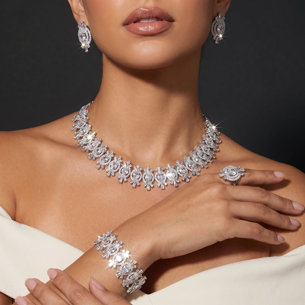 Model wearing a silver crystal necklace, matching earrings, bracelet and statement ring